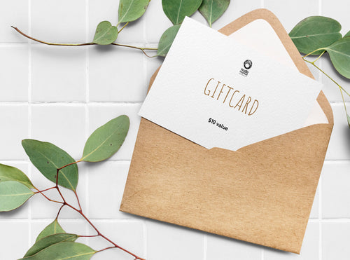 Envelop with paper gift card peeking out, with nudemarket logo and reads 